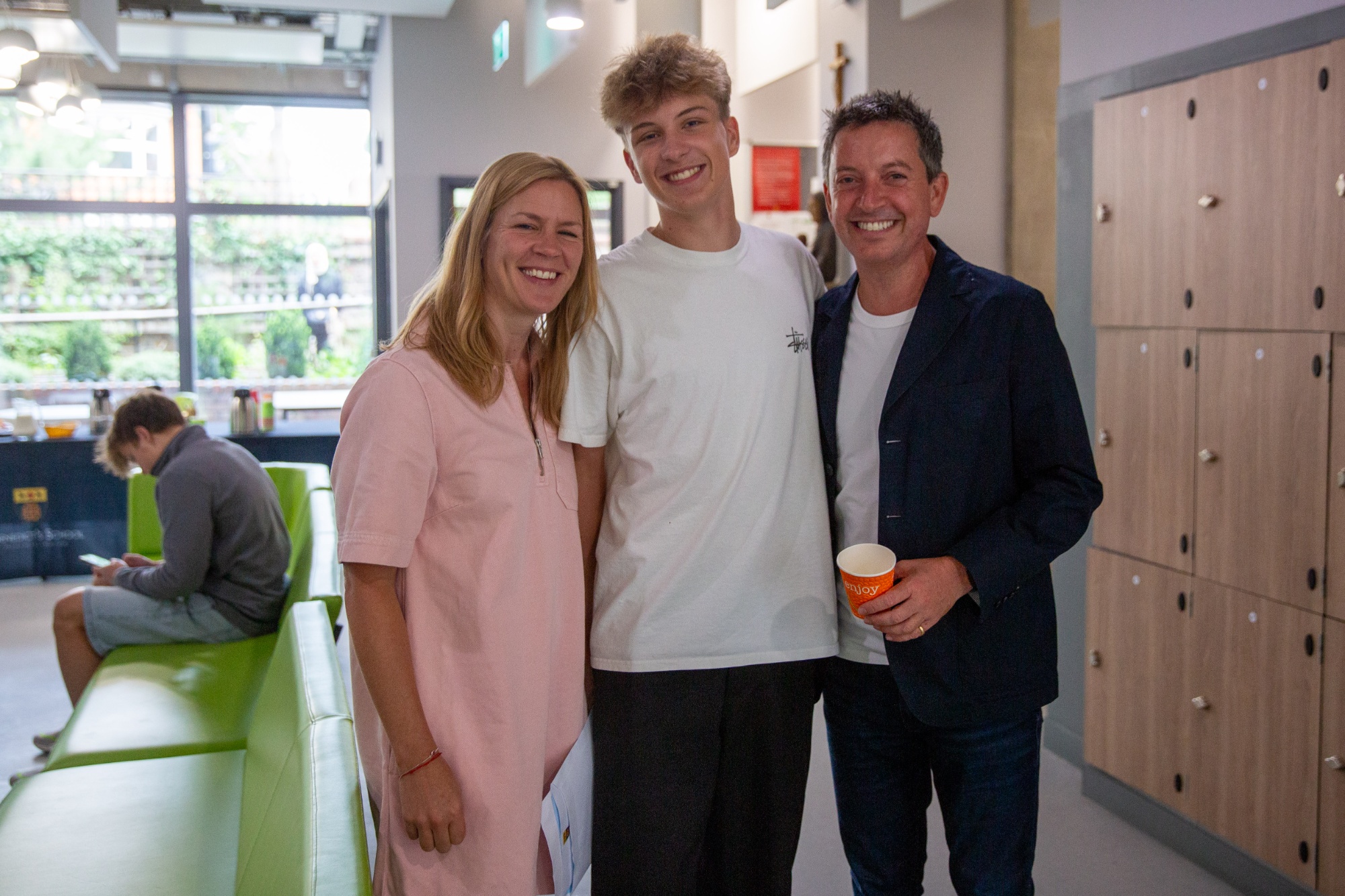 students celebrating GCSE results with parents